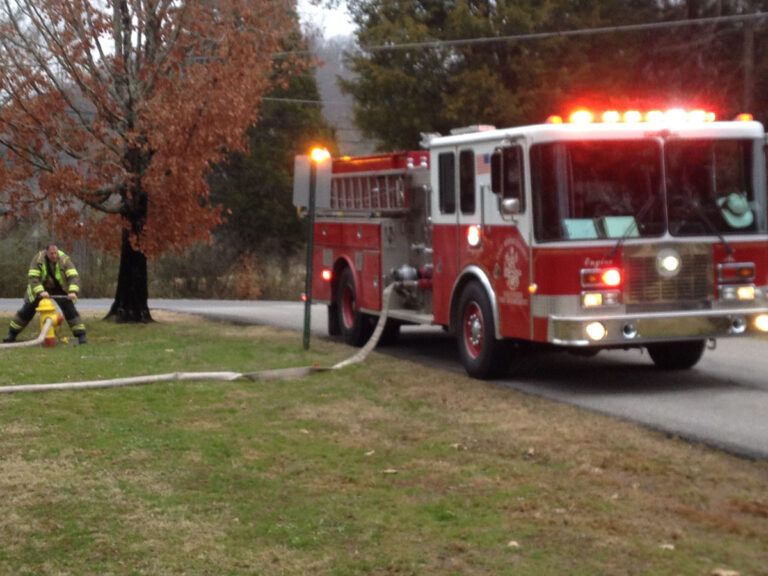 Filling Engine 5 from a hydrant on church grounds.